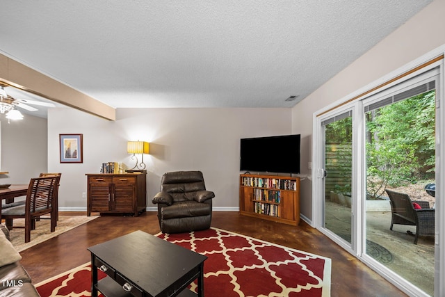 6021 Dixon Dr, Raleigh, NC 27609 - living area with concrete floors, a textured ceiling, and a ceiling fan