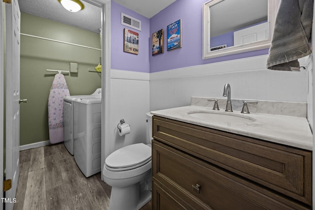 6021 Dixon Dr, Raleigh, NC 27609 - bathroom with wood finished floors, independent washer and dryer, and vanity