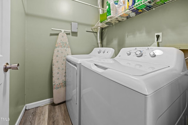 6021 Dixon Dr, Raleigh, NC 27609 - washroom featuring washer and clothes dryer and wood finished floors