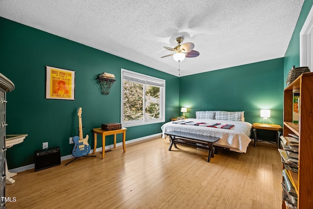 6021 Dixon Dr, Raleigh, NC 27609 - bedroom featuring a textured ceiling, ceiling fan, and wood finished floors