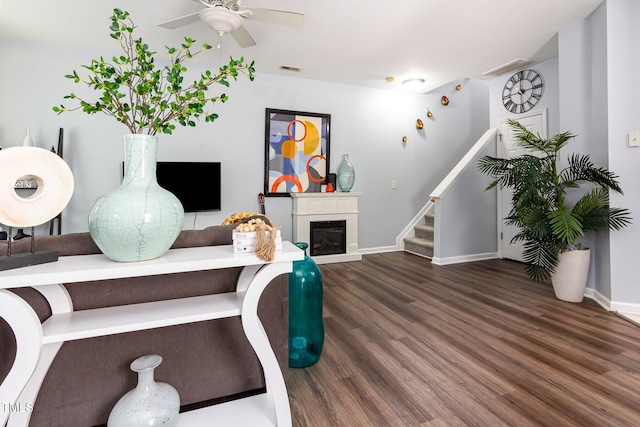 320 Gilman Ln Unit 106, Raleigh, NC 27610 - living room featuring wood finished floors, stairs, ceiling fan, and a glass covered fireplace
