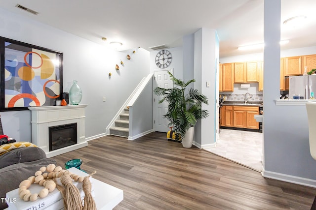 320 Gilman Ln Unit 106, Raleigh, NC 27610 - living room featuring wood finished floors, stairway, and a glass covered fireplace