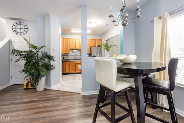320 Gilman Ln Unit 106, Raleigh, NC 27610 - dining area featuring light wood-style flooring and a chandelier