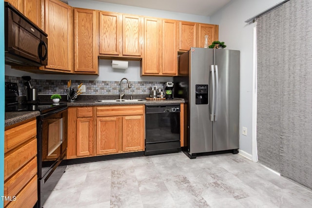 320 Gilman Ln Unit 106, Raleigh, NC 27610 - kitchen featuring black appliances, backsplash, and dark countertops