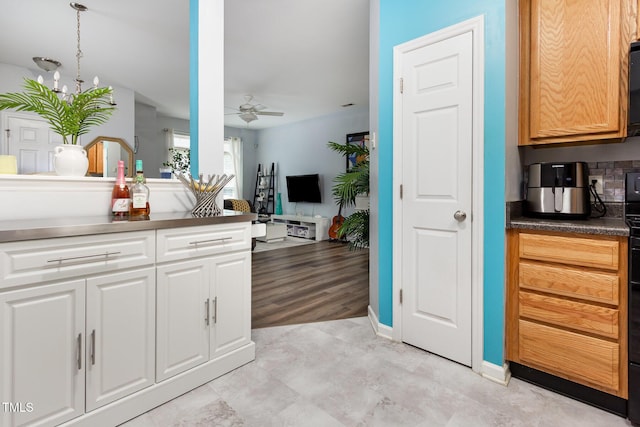 320 Gilman Ln Unit 106, Raleigh, NC 27610 - kitchen with a ceiling fan, dark countertops, white cabinetry, backsplash, and open floor plan