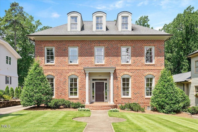 1313 Duplin Rd, Raleigh, NC 27607 - colonial house featuring brick siding, a front lawn, and a shingled roof