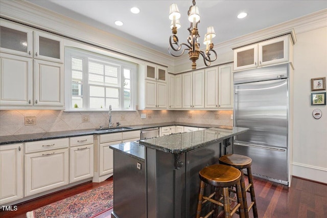 1313 Duplin Rd, Raleigh, NC 27607 - kitchen featuring stainless steel appliances, a chandelier, dark wood finished floors, a kitchen island, and a breakfast bar area