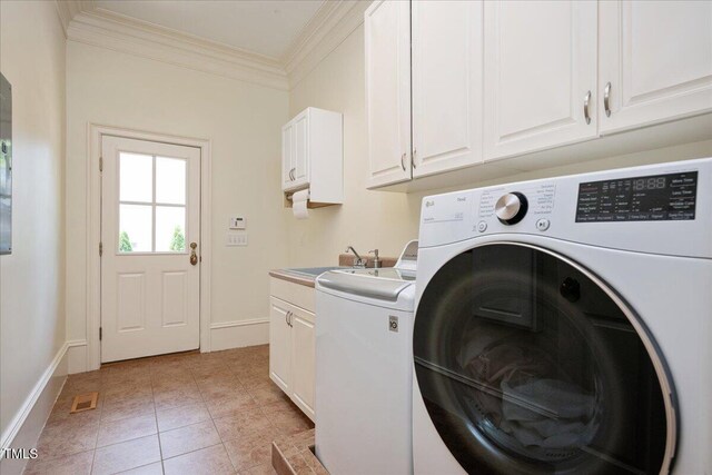 1313 Duplin Rd, Raleigh, NC 27607 - washroom featuring cabinet space, ornamental molding, washing machine and clothes dryer, and light tile patterned flooring