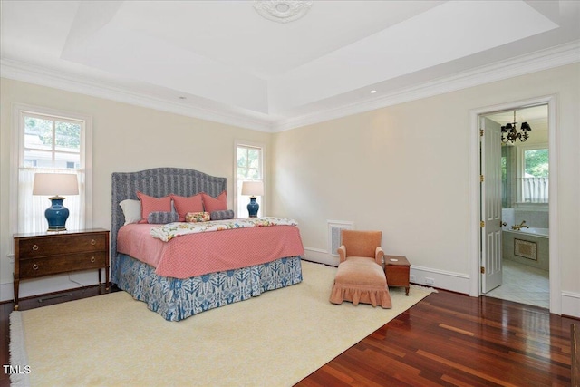 1313 Duplin Rd, Raleigh, NC 27607 - bedroom featuring wood finished floors, a raised ceiling, crown molding, a chandelier, and connected bathroom