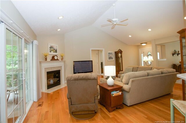 957 Blackeyed Susan Pl, Vass, NC 28394 - living area featuring a ceiling fan, vaulted ceiling, a premium fireplace, light wood-style flooring, and recessed lighting