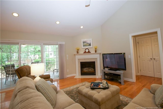 957 Blackeyed Susan Pl, Vass, NC 28394 - living area with vaulted ceiling, light wood finished floors, a high end fireplace, and recessed lighting