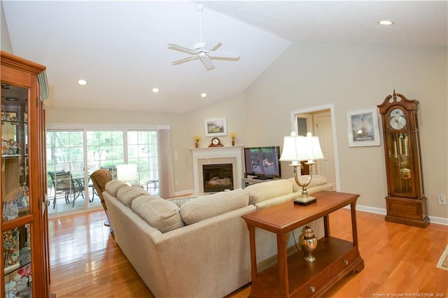 957 Blackeyed Susan Pl, Vass, NC 28394 - living area with ceiling fan, light wood finished floors, a glass covered fireplace, recessed lighting, and high vaulted ceiling