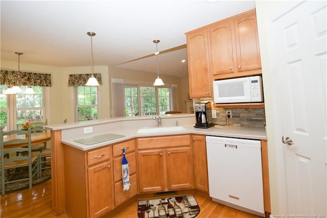 957 Blackeyed Susan Pl, Vass, NC 28394 - kitchen with white appliances, a peninsula, light wood-type flooring, light countertops, and backsplash