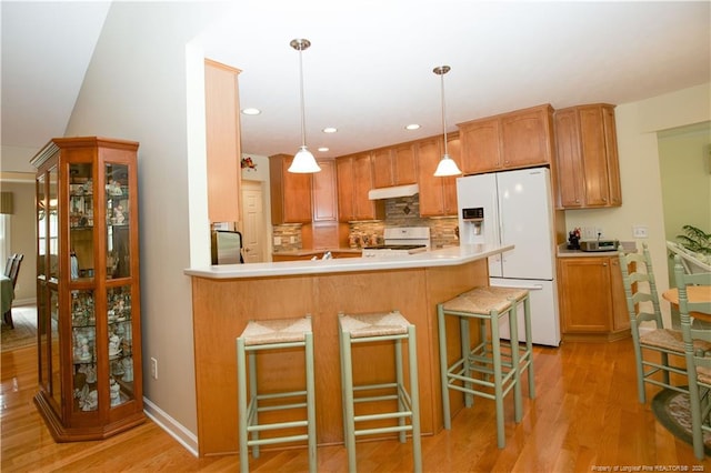 957 Blackeyed Susan Pl, Vass, NC 28394 - kitchen with white fridge with ice dispenser, range, light wood-style floors, fridge, and a peninsula