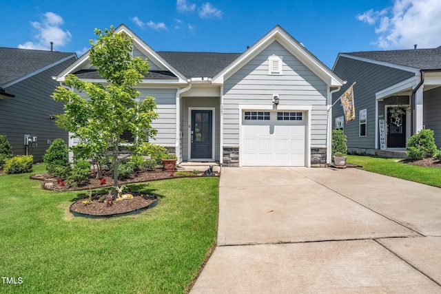 1247 White Flint Cir, Durham, NC 27703 - view of front of home featuring an attached garage, concrete driveway, a front yard, and stone siding