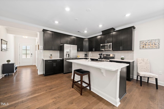 1247 White Flint Cir, Durham, NC 27703 - kitchen with appliances with stainless steel finishes, ornamental molding, decorative backsplash, dark wood-style floors, and a breakfast bar area