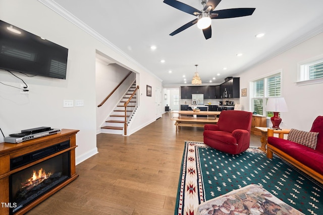 1247 White Flint Cir, Durham, NC 27703 - living area featuring ornamental molding, stairway, recessed lighting, wood finished floors, and ceiling fan