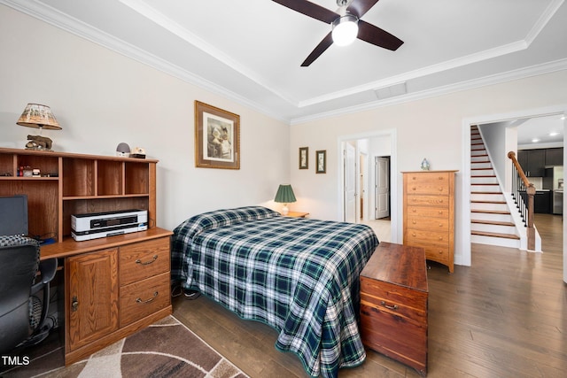 1247 White Flint Cir, Durham, NC 27703 - bedroom featuring a tray ceiling, dark wood-style floors, ornamental molding, a ceiling fan, and a desk