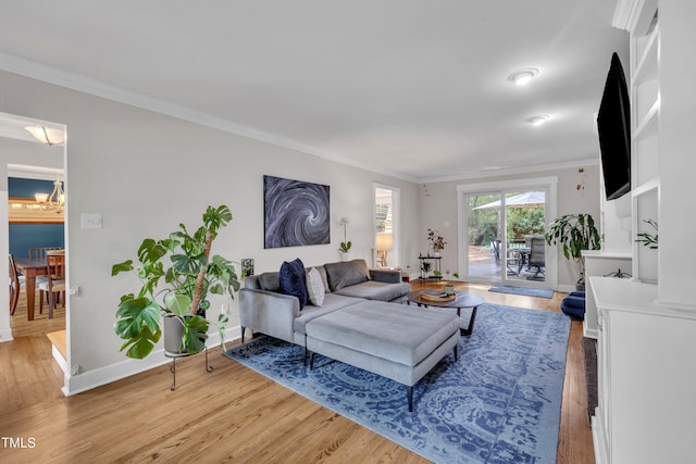 7917 Featherstone Dr, Raleigh, NC 27615 - living area featuring light wood-type flooring, a chandelier, and crown molding
