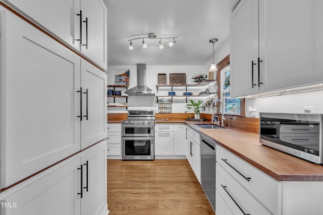 7917 Featherstone Dr, Raleigh, NC 27615 - kitchen with appliances with stainless steel finishes, wall chimney exhaust hood, butcher block countertops, open shelves, and white cabinets