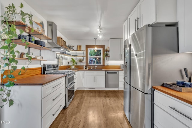 7917 Featherstone Dr, Raleigh, NC 27615 - kitchen featuring open shelves, stainless steel appliances, butcher block countertops, and island exhaust hood