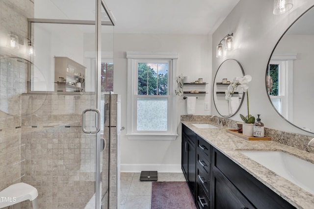 7917 Featherstone Dr, Raleigh, NC 27615 - full bath featuring double vanity, tile patterned floors, and a stall shower