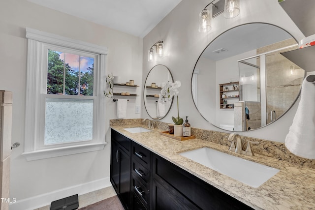 7917 Featherstone Dr, Raleigh, NC 27615 - bathroom featuring double vanity and a stall shower