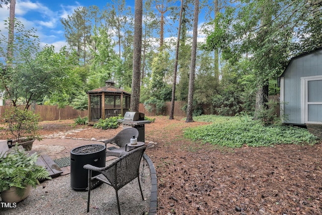 7917 Featherstone Dr, Raleigh, NC 27615 - fenced backyard featuring a gazebo, a fire pit, a shed, and a patio