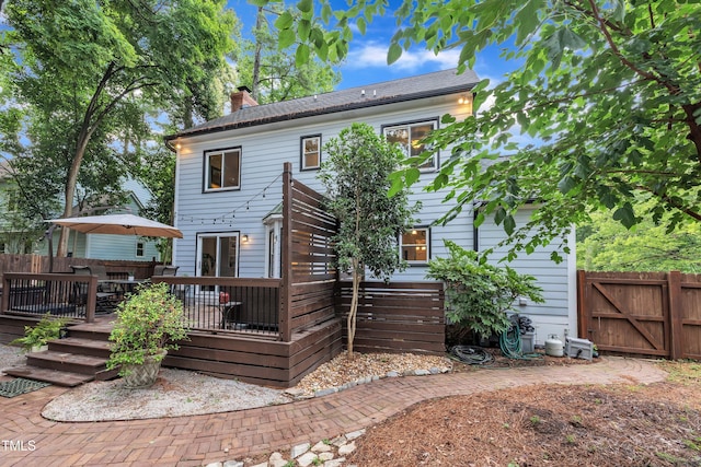 7917 Featherstone Dr, Raleigh, NC 27615 - back of property with a deck, a chimney, and a gate