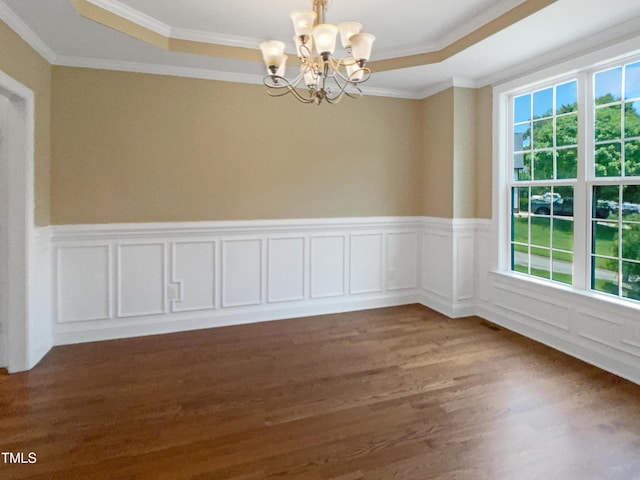 1201 Dagmar Ln, Wake Forest, NC 27587 - spare room featuring a chandelier, dark wood-type flooring, a tray ceiling, crown molding, and a wainscoted wall