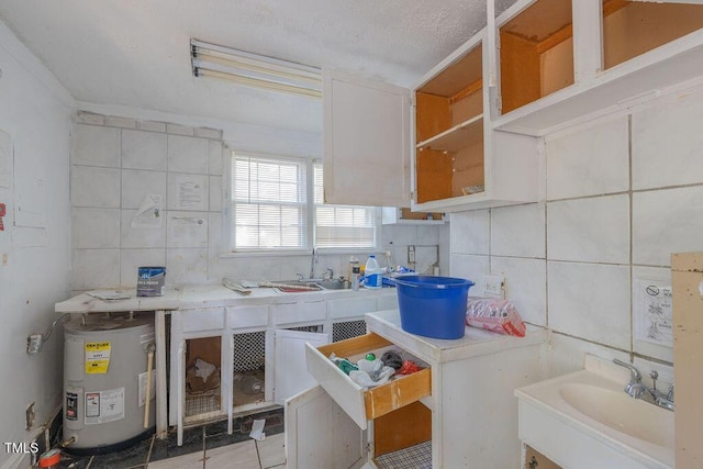 301 N King Charles Rd, Raleigh, NC 27610 - kitchen featuring water heater, light countertops, white cabinets, and tile walls