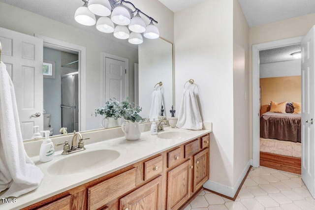 116 Twin Oaks Pl, Goldsboro, NC 27530 - full bathroom with a shower stall, double vanity, tile patterned floors, connected bathroom, and a chandelier