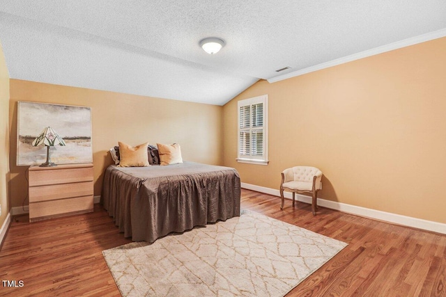 116 Twin Oaks Pl, Goldsboro, NC 27530 - bedroom featuring wood finished floors, a textured ceiling, lofted ceiling, and ornamental molding