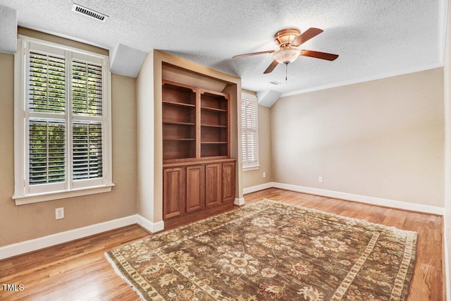 116 Twin Oaks Pl, Goldsboro, NC 27530 - unfurnished living room featuring ceiling fan, a textured ceiling, and wood finished floors