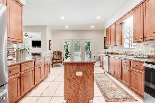 116 Twin Oaks Pl, Goldsboro, NC 27530 - kitchen with a center island, backsplash, stainless steel appliances, ornamental molding, and light stone counters