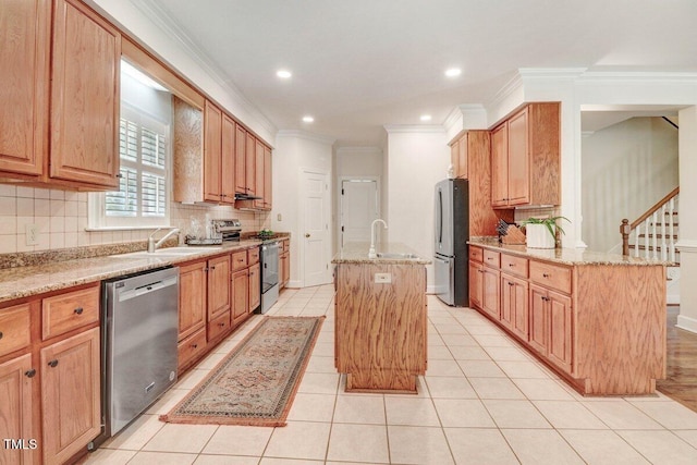 116 Twin Oaks Pl, Goldsboro, NC 27530 - kitchen with stainless steel appliances, a center island with sink, ornamental molding, light stone counters, and decorative backsplash