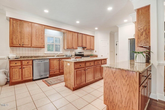 116 Twin Oaks Pl, Goldsboro, NC 27530 - kitchen with appliances with stainless steel finishes, crown molding, a center island with sink, tasteful backsplash, and light stone counters