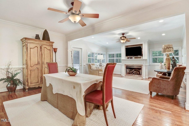 116 Twin Oaks Pl, Goldsboro, NC 27530 - dining room with a ceiling fan, a fireplace, light wood-style flooring, recessed lighting, and ornamental molding