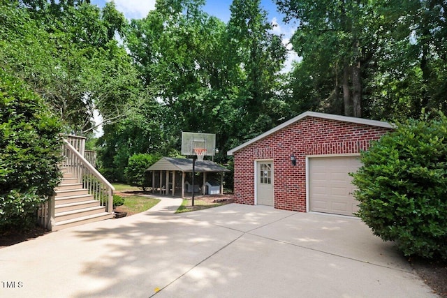116 Twin Oaks Pl, Goldsboro, NC 27530 - garage with concrete driveway and view of scattered trees