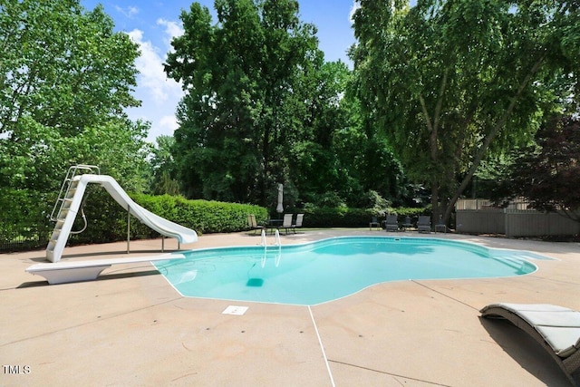 116 Twin Oaks Pl, Goldsboro, NC 27530 - view of pool with a water slide, a patio area, a diving board, and view of scattered trees