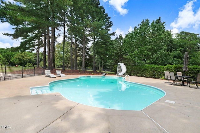 116 Twin Oaks Pl, Goldsboro, NC 27530 - view of pool featuring a water slide, a patio, and view of scattered trees