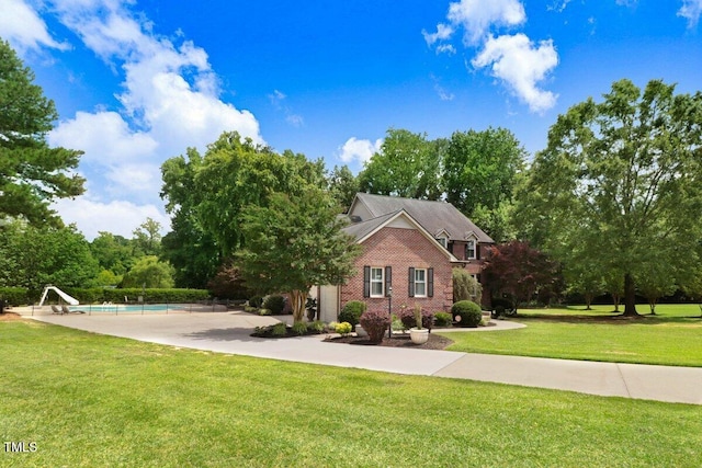 116 Twin Oaks Pl, Goldsboro, NC 27530 - view of front of home featuring brick siding, an outdoor pool, and a front yard