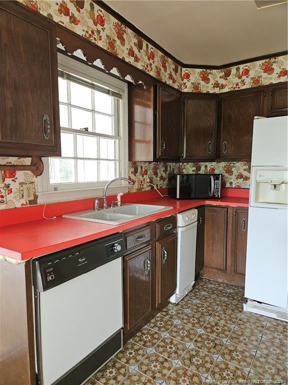 2943 Ole Bluff Mill Rd, Fayetteville, NC 28306 - kitchen with white appliances, wallpapered walls, and dark brown cabinets