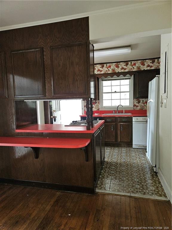 2943 Ole Bluff Mill Rd, Fayetteville, NC 28306 - kitchen featuring freestanding refrigerator, dark wood finished floors, dark brown cabinets, ornamental molding, and stainless steel gas stovetop