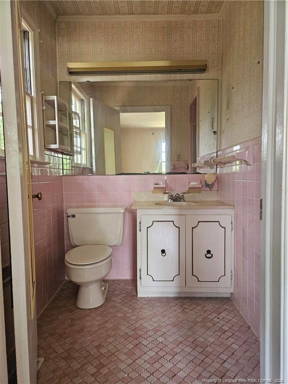 2943 Ole Bluff Mill Rd, Fayetteville, NC 28306 - half bath featuring tile walls, vanity, and wallpapered walls