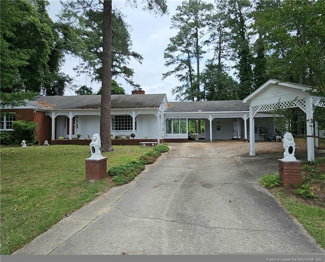 2943 Ole Bluff Mill Rd, Fayetteville, NC 28306 - ranch-style home with a front lawn, driveway, an attached carport, and a chimney
