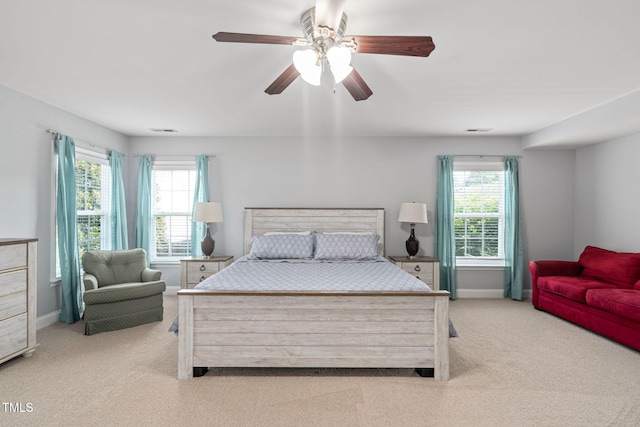 200 Woodvale Way, Fuquay Varina, NC 27526 - carpeted bedroom featuring multiple windows and ceiling fan