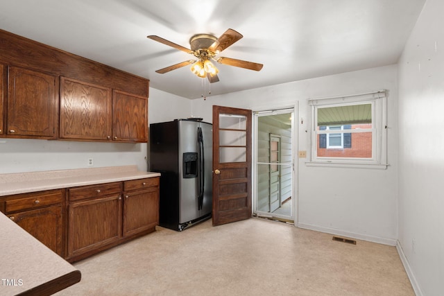 218 Forestville Rd, Wake Forest, NC 27587 - kitchen with stainless steel refrigerator with ice dispenser, light countertops, ceiling fan, and brown cabinets
