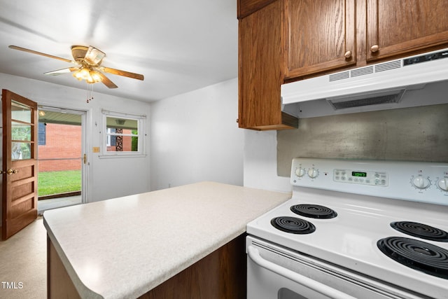 218 Forestville Rd, Wake Forest, NC 27587 - kitchen featuring electric range, under cabinet range hood, a peninsula, ceiling fan, and light countertops