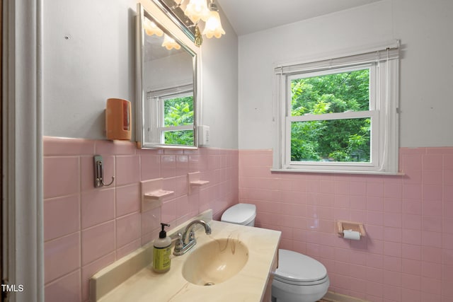 218 Forestville Rd, Wake Forest, NC 27587 - half bathroom featuring tile walls, wainscoting, and vanity